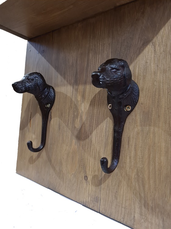 houten hondenkapstok met twee gietijzeren haken van dichtbij